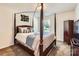 Bedroom with a four-poster bed, carpet, and natural light from a window at 8726 Addingham Dr, Charlotte, NC 28269