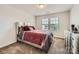 Bedroom boasts a decorative bed frame, patterned bedding, and a well-lit window at 8726 Addingham Dr, Charlotte, NC 28269