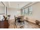 Bright dining area boasts a modern light fixture, tray ceiling, and large windows for natural light at 8726 Addingham Dr, Charlotte, NC 28269