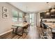 Bright dining area with modern table, bench seating, and sliding glass doors to outdoor space at 8726 Addingham Dr, Charlotte, NC 28269
