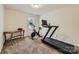 Exercise room featuring a treadmill, stationary bike, and desk for home workouts at 8726 Addingham Dr, Charlotte, NC 28269