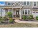 Inviting front porch with stone accents, lush landscaping, and an elegant front door at 8726 Addingham Dr, Charlotte, NC 28269