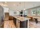 Open concept kitchen and living room featuring stainless steel appliances, granite countertops, and hardwood floors at 8726 Addingham Dr, Charlotte, NC 28269