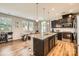 Modern kitchen showcases an island with granite countertops, stainless steel appliances, and dark cabinetry at 8726 Addingham Dr, Charlotte, NC 28269