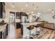 Open-concept kitchen with dark cabinetry, granite countertops, and stainless steel appliances, adjacent to the living room at 8726 Addingham Dr, Charlotte, NC 28269