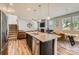 Open-concept kitchen seamlessly transitions into the living room, boasting granite countertops and stainless appliances at 8726 Addingham Dr, Charlotte, NC 28269
