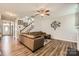 Spacious living room featuring wood floors, a comfortable leather sofa, and stylish decor at 8726 Addingham Dr, Charlotte, NC 28269