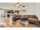 Open-concept living room with a large leather sofa, a stylish rug, and a view of the kitchen and dining area at 8726 Addingham Dr, Charlotte, NC 28269