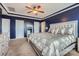 Relaxing main bedroom featuring a tray ceiling, plush carpet, and a stylish bed with decorative pillows at 8726 Addingham Dr, Charlotte, NC 28269