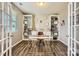 Bright home office with built-in bookshelves, a modern desk, and ample natural light from the window at 8726 Addingham Dr, Charlotte, NC 28269