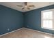 Neutral bedroom featuring light carpeting, natural light and a ceiling fan at 9315 Pebble Creek Way, Charlotte, NC 28269