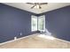 Bedroom featuring blue walls, neutral carpet, ceiling fan, and a window that provides ample natural light at 9315 Pebble Creek Way, Charlotte, NC 28269