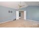 Spacious bedroom featuring a neutral color palette, fan and ensuite access at 9315 Pebble Creek Way, Charlotte, NC 28269