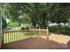 Wood deck overlooking a lush, landscaped backyard with mature trees and green grass at 9315 Pebble Creek Way, Charlotte, NC 28269