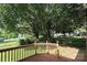Home featuring wood deck with a view of the lush backyard at 9315 Pebble Creek Way, Charlotte, NC 28269