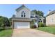 Charming two-story home with a well-manicured lawn and a spacious two-car garage at 9315 Pebble Creek Way, Charlotte, NC 28269