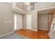 Spacious foyer with hardwood flooring, a staircase, and two entry doors at 9315 Pebble Creek Way, Charlotte, NC 28269