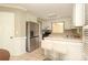Well-lit kitchen with stainless steel appliances and barstool seating at the counter at 9315 Pebble Creek Way, Charlotte, NC 28269