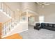 Bright, open-concept living room with a staircase and comfortable seating arrangement at 9315 Pebble Creek Way, Charlotte, NC 28269