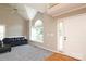 Open-concept living room with a vaulted ceiling, large window, and comfortable seating arrangement at 9315 Pebble Creek Way, Charlotte, NC 28269