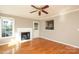 Cozy living room with a traditional fireplace, hardwood floors, and natural light at 9315 Pebble Creek Way, Charlotte, NC 28269