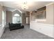 Cozy living room featuring a vaulted ceiling, large window, and open staircase at 9315 Pebble Creek Way, Charlotte, NC 28269
