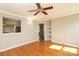 Bright living room featuring hardwood floors, a ceiling fan, and neutral paint at 9315 Pebble Creek Way, Charlotte, NC 28269