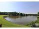 Scenic view of a tranquil pond surrounded by lush trees and greenery at 9315 Pebble Creek Way, Charlotte, NC 28269