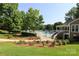 Community clubhouse adjacent to a well-maintained pool and garden, with manicured landscaping at 9315 Pebble Creek Way, Charlotte, NC 28269