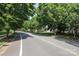 Quiet street lined with mature trees and well-maintained homes in a peaceful neighborhood at 9315 Pebble Creek Way, Charlotte, NC 28269