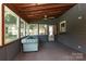 Bright sunroom with wood paneled ceiling, carpet flooring, and array of bright windows at 9315 Pebble Creek Way, Charlotte, NC 28269