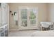 Bright bedroom featuring a desk, mirror, and french doors leading to a private balcony at 10401 Royal Winchester Dr, Charlotte, NC 28277