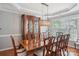 Elegant dining room with a large wooden table and hutch, perfect for Gathering meals and entertaining at 10401 Royal Winchester Dr, Charlotte, NC 28277
