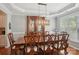Elegant dining room with a large wooden table and hutch, perfect for Gathering meals and entertaining at 10401 Royal Winchester Dr, Charlotte, NC 28277