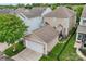 Tan two-story home features an attached two-car garage and fenced backyard at 10401 Royal Winchester Dr, Charlotte, NC 28277