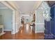 Inviting foyer with hardwood floors, elegant lighting, and views into the living spaces at 10401 Royal Winchester Dr, Charlotte, NC 28277