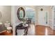 Grand foyer with wood floors, an oval mirror and a view to the dining room provides an inviting atmosphere at 10401 Royal Winchester Dr, Charlotte, NC 28277