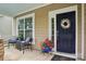 Welcoming front porch with seating and a charming front door, creating a warm entry at 10401 Royal Winchester Dr, Charlotte, NC 28277
