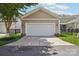 Attached two-car garage, with a white door, sits next to the home in a fenced yard at 10401 Royal Winchester Dr, Charlotte, NC 28277