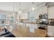 A modern kitchen with granite countertops, stainless steel appliances, and pendant lighting over the island at 10401 Royal Winchester Dr, Charlotte, NC 28277