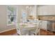 Inviting eat-in kitchen with white table, chairs, and natural light from nearby windows at 10401 Royal Winchester Dr, Charlotte, NC 28277