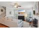 Comfortable living room features a ceiling fan, fireplace, and large windows providing ample natural light at 10401 Royal Winchester Dr, Charlotte, NC 28277