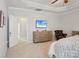 The main bedroom showcasing a TV, leather chair, and beautiful dressers at 10401 Royal Winchester Dr, Charlotte, NC 28277