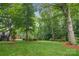 A beautiful, green backyard features mature trees and a well-maintained lawn at 10616 Back Ridge Rd, Charlotte, NC 28277