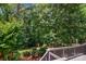 A picturesque backyard with lush trees, a neatly manicured lawn, and an outdoor lamppost at 10616 Back Ridge Rd, Charlotte, NC 28277