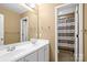 Neutral colored bathroom has a double sink vanity and shower/tub combination with privacy curtain at 10616 Back Ridge Rd, Charlotte, NC 28277