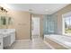 Spacious primary bathroom features a walk-in shower, soaking tub, and dual sink vanity at 10616 Back Ridge Rd, Charlotte, NC 28277