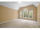 Spacious, bright bedroom offers plush carpeting, lots of natural light, and vaulted ceilings at 10616 Back Ridge Rd, Charlotte, NC 28277