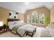 Bright primary bedroom with large windows, a vaulted ceiling, and modern decor at 10616 Back Ridge Rd, Charlotte, NC 28277