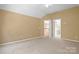 Neutral bonus room featuring a vaulted ceiling, carpeted floors, and a glimpse of the second-floor railing at 10616 Back Ridge Rd, Charlotte, NC 28277